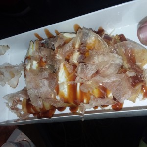 Some delicious omelet thing with meat, onions, cabbage, and sauce.